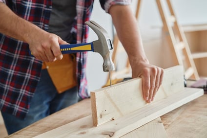 carpenter-using-a-hammer-to-drive-nail-2021-08-28-15-07-26-utc