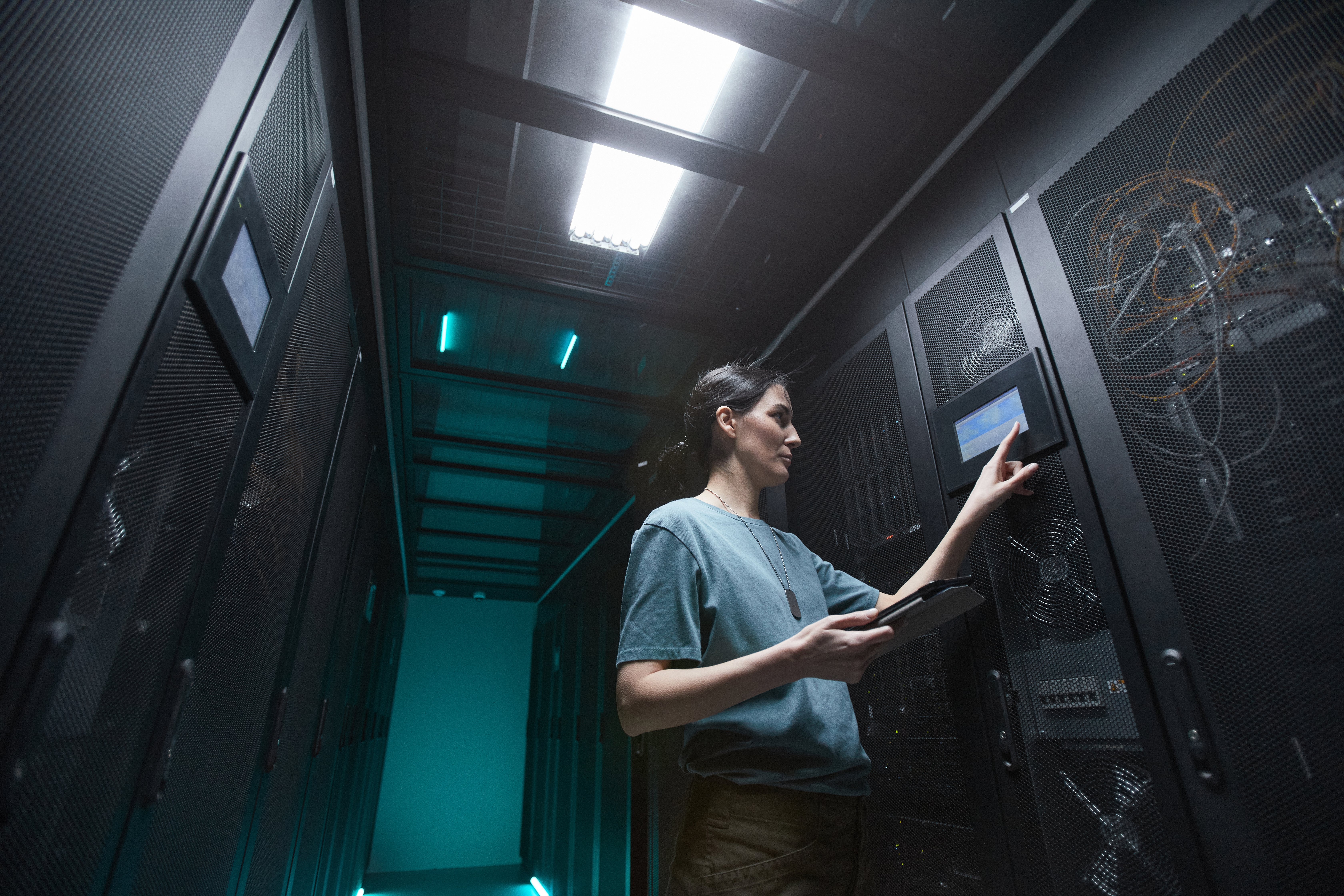 female-it-technician-managing-server-in-data-cente-2021-09-24-04-17-22-utc