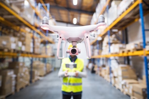 man-with-drone-in-a-warehouse-2023-11-27-05-20-35-utc