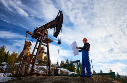 oil-worker-standing-by-oil-well-pump-jack-2022-05-25-02-25-19-utc